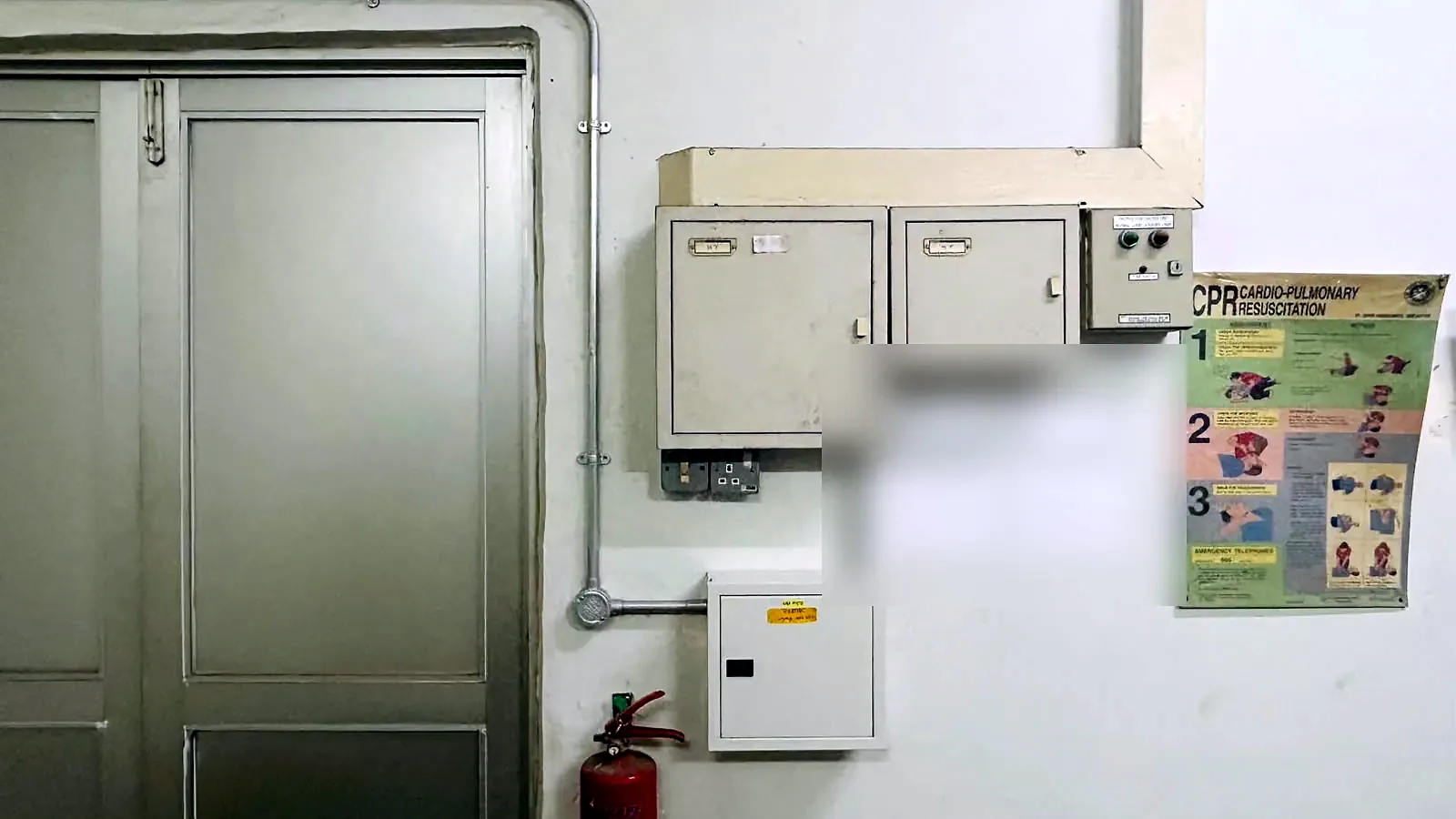 Switchroom with distribution boards, safety signage and the installation licence posted